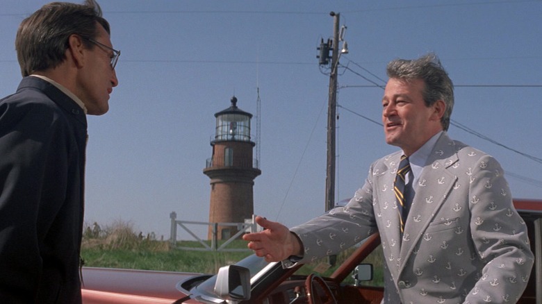 Brody talking to Mayor Vaughn with a lighthouse in the background in "Jaws"