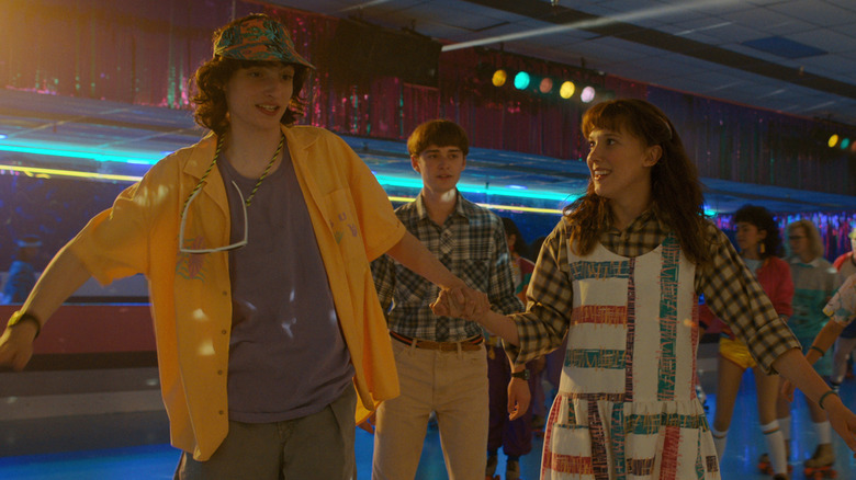 El and Mike roller skating with Will behind them on "Stranger Things" (2016-2025)