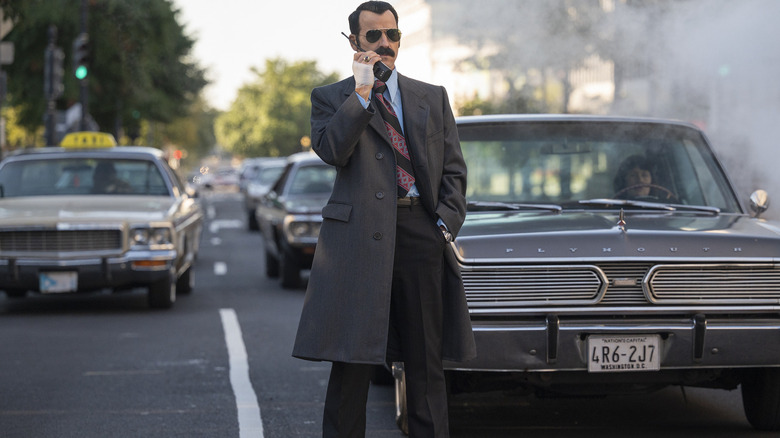 G. Gordon Liddy standing in a roadway