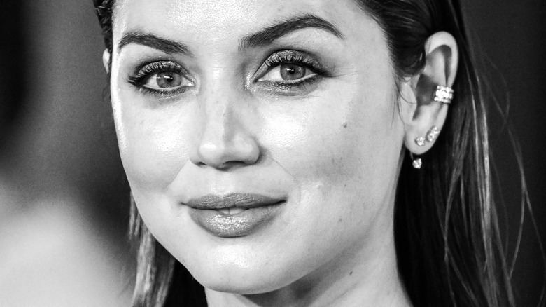 Ana de Armas in black and white smiling