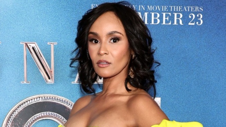 Kris Sidberry posing in a yellow dress