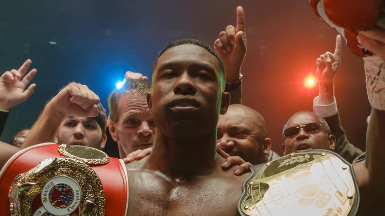 Trevante Rhodes with belts in Mike