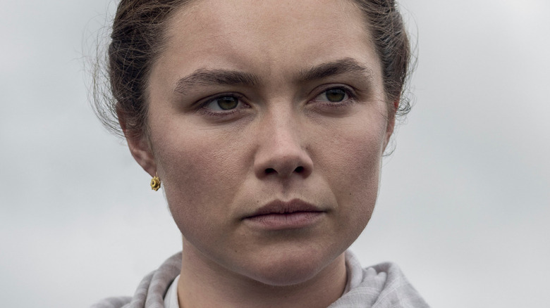 Florence Pugh with gray sky behind her