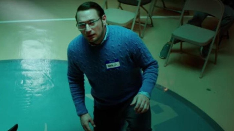 Mark crouching on floor