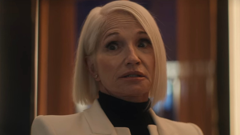 Ellen Barkin grimaces wearing a white suit