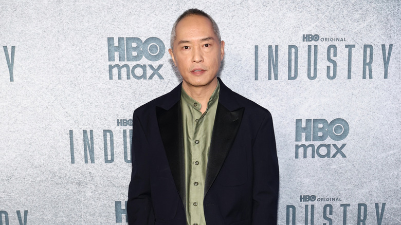 Ken Leung wearing a green shirt and suit at the Industry S4 premiere