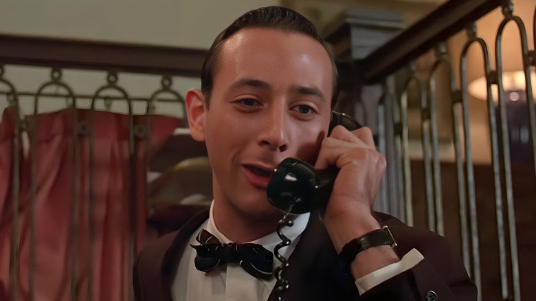 The bellhop smugly talking on the phone