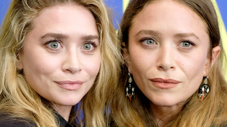 Mary-Kate and Ashley Olsen posing together