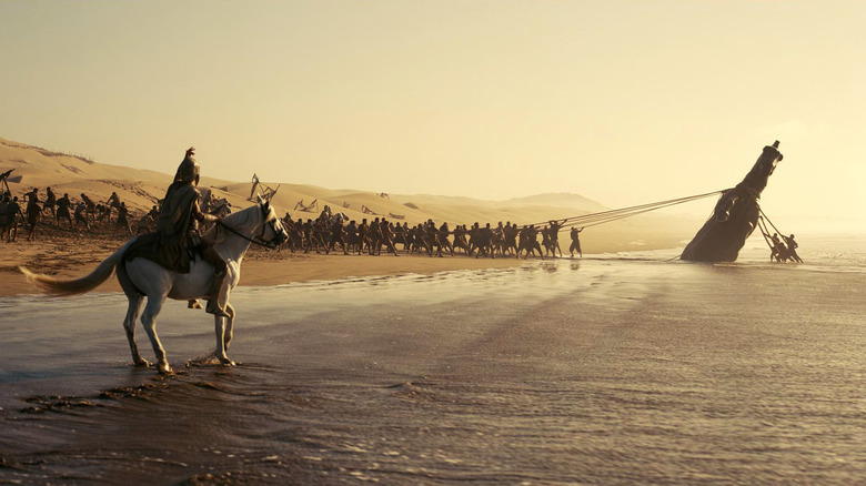 Trojans pull the Trojan Horse out of the ocean in "The Odyssey" (2026)