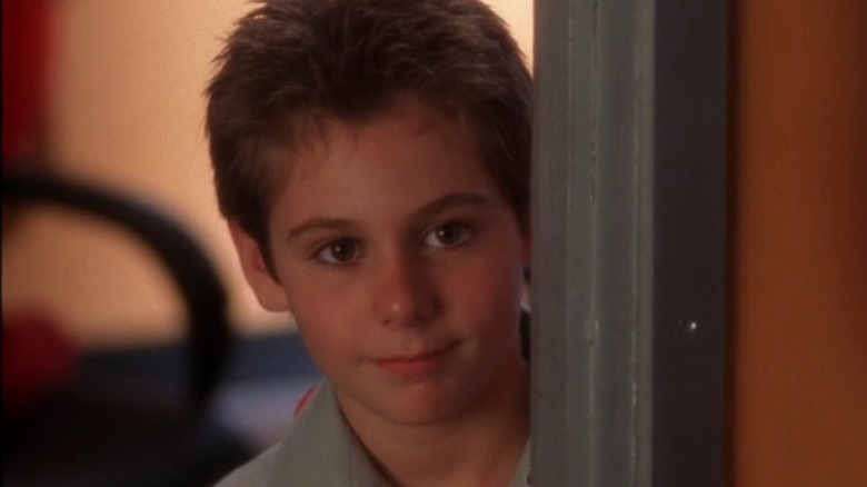 Carson Matthews peering through doorway