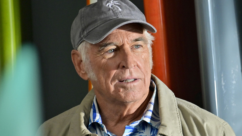 Dickie Delaney wearing grey hat and beige jacket