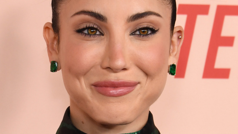 Briana Cuoco smiling green earrings