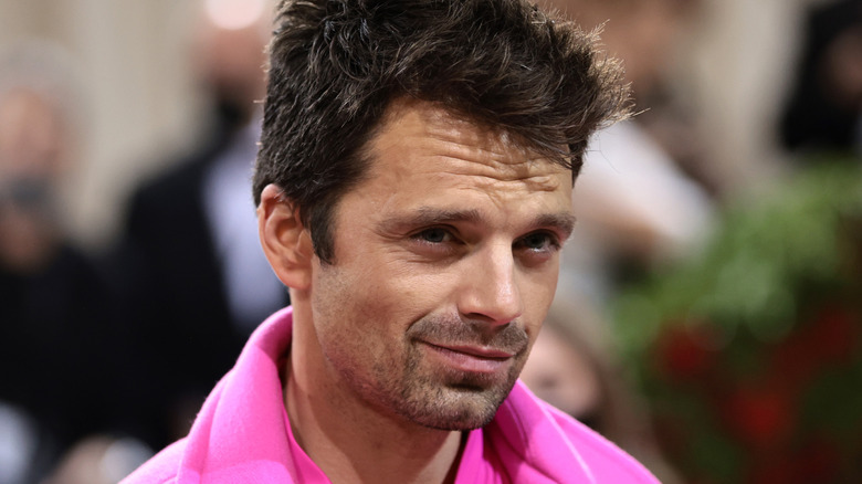 Sebastian Stan smiling in hot pink outfit