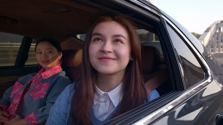 Kitty smiling out of a car window