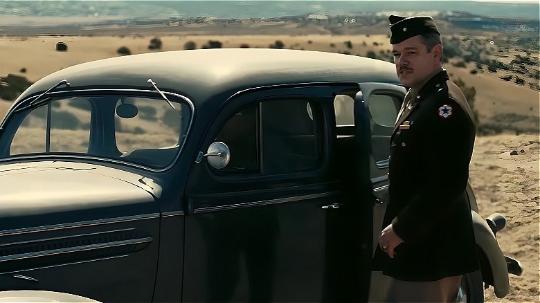 Leslie Groves standing by car