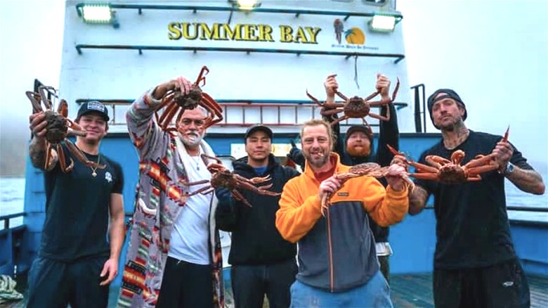 Summer Bay crew posing with crabs. 