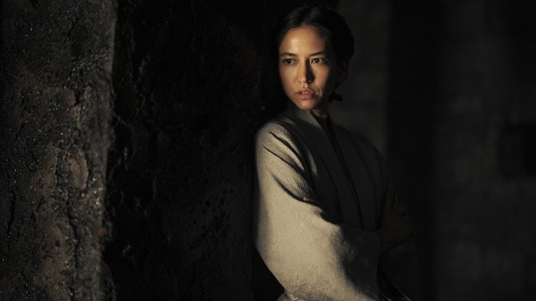 Mysaria in near darkness looking at something on House of the Dragon