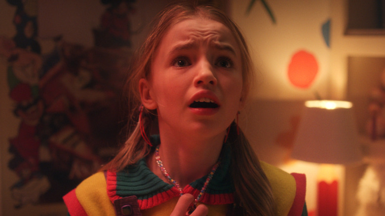 Holly looking scared holding her necklace in Stranger Things 5