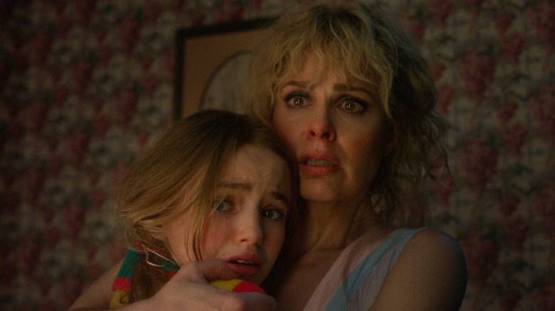 Karen holding Holly and looking frightened in Stranger Things 5