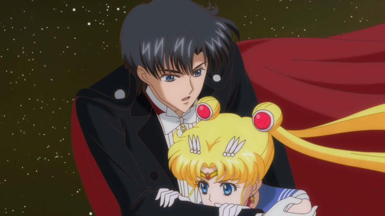 Tuxedo Mask holds Sailor Moon