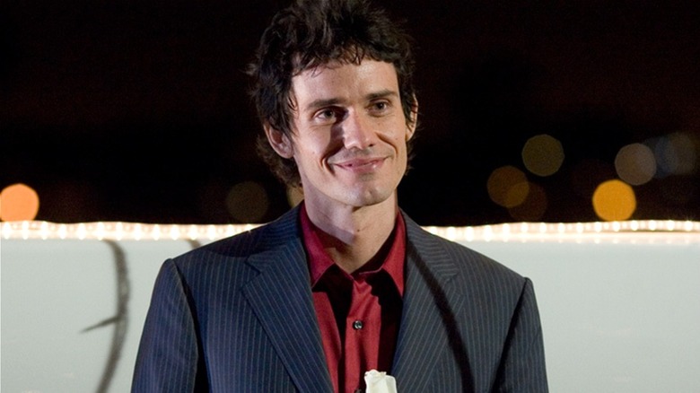 Brian Moser smiles menacingly at someone in 