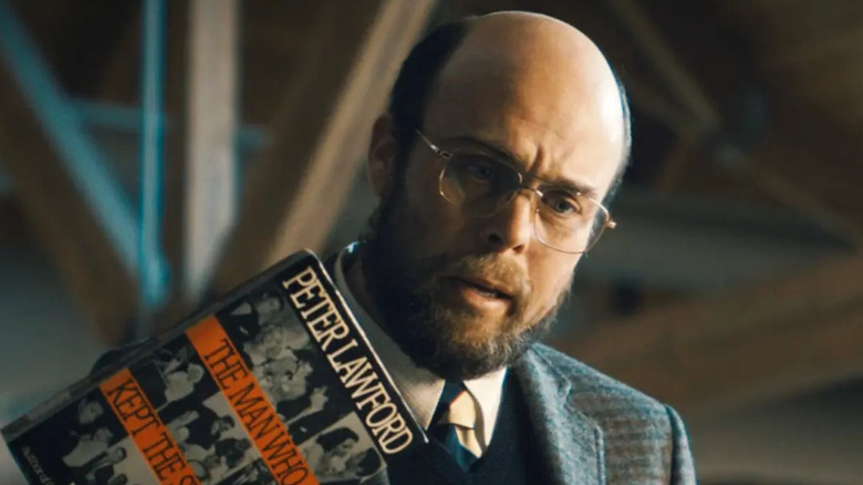 Trent holds up Cal's instructions for getting to the surface in "Paradise" (2025)