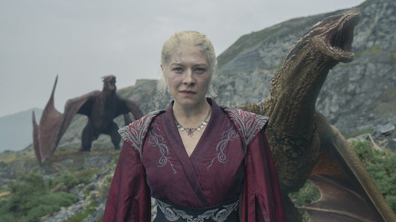 Rhaenyra sneering with two dragons behind her in House of the Dragon