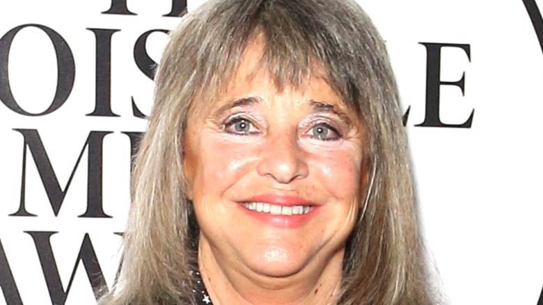 Singer Suzi Quatro poses at an event.