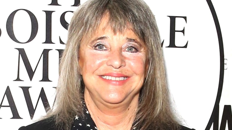 Singer Suzi Quatro poses at an event.