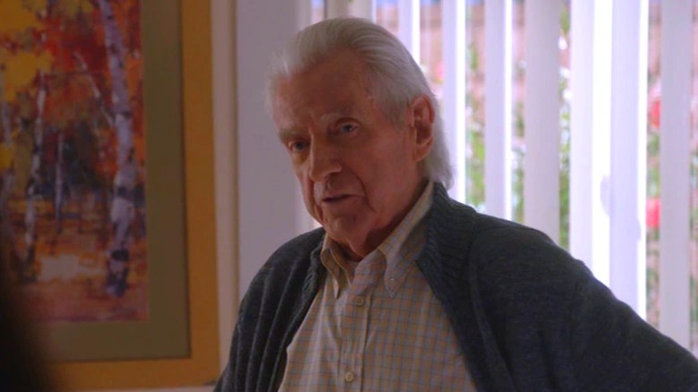 Roman Parker wearing a cardigan