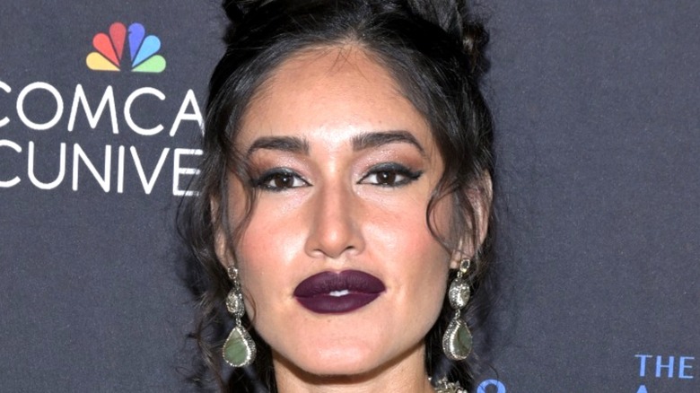 Q'orianka Kilcher looking at camera