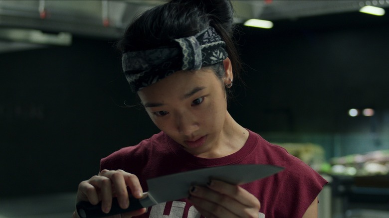 Aoy wearing looking at a knife