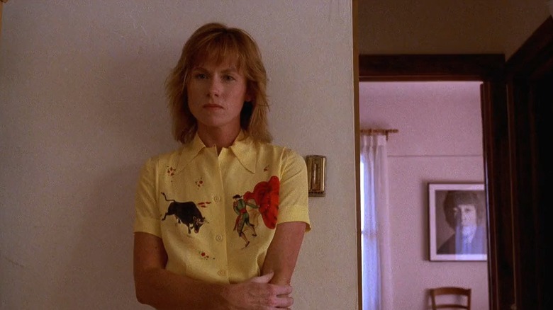 Annie in a yellow shirt standing against a wall in the Kinsella home in Field of Dreams