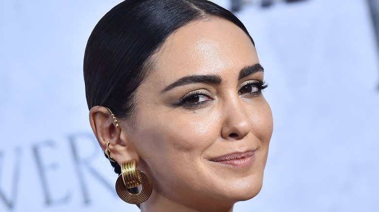 Nazanin Boniadi smirking at a premiere