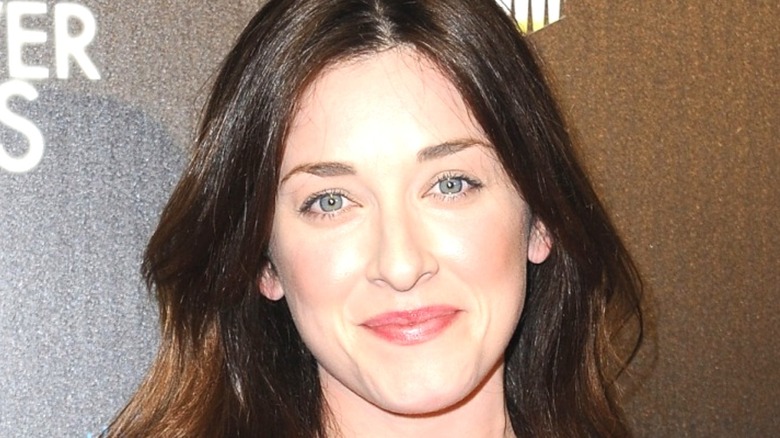 Margo Harshman smiling black background