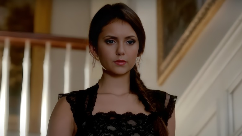 Elena walking down stairs