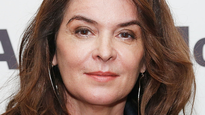 Annabella Sciorra looking ahead smiling
