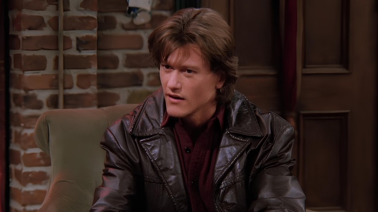 Fun Bobby sitting on armchair in leather jacket