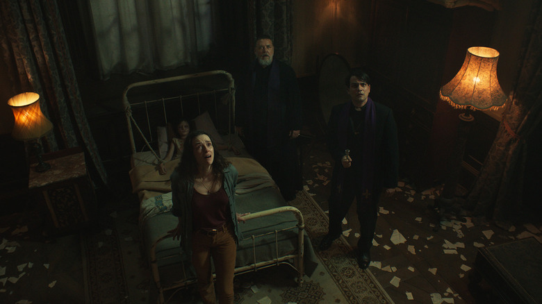 Father Amorth, Father Esquibel, Julia, and Henry looking up