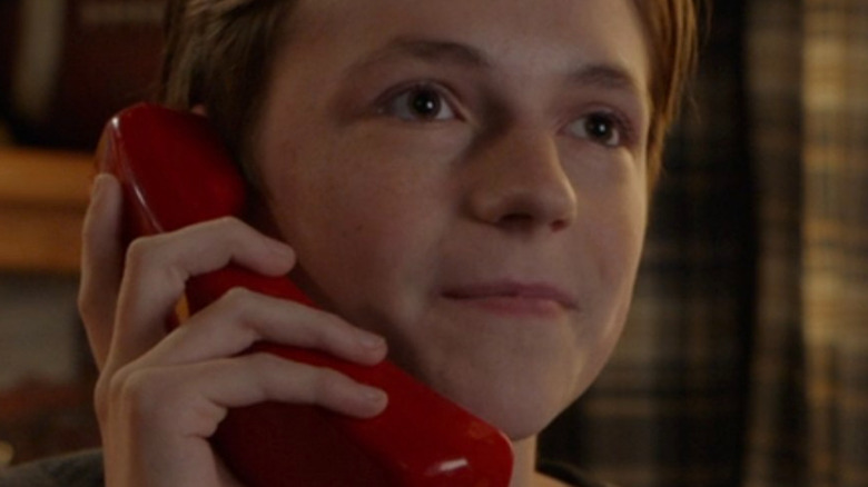 Dean talking into a red phone