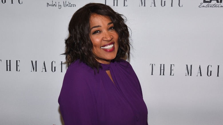 Kym Whitley smiling at a red carpet event