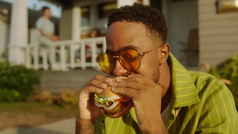 Man biting into Whopper