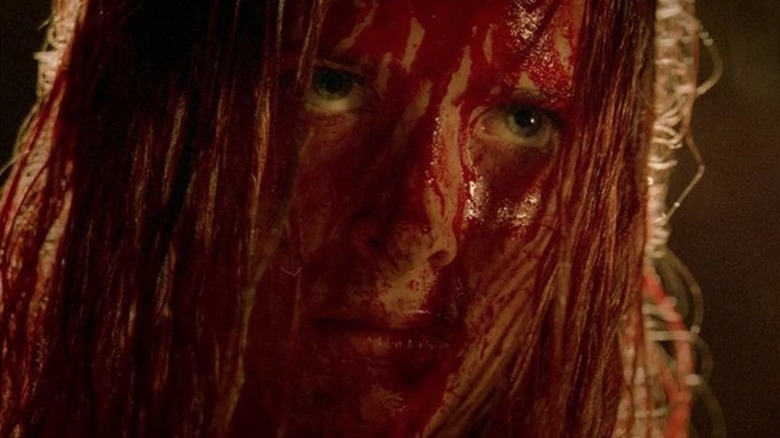 Sarah with blood-soaked face in The Descent