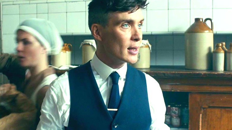Tommy Shelby stands in a kitchen in 