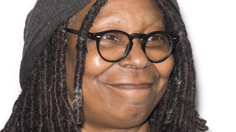 Whoopi Goldberg black glasses closed smile