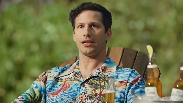 Andy Samberg sitting at beach