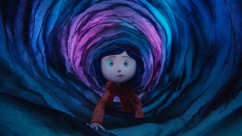 Coraline walking through a magical tunnel in Coraline (2009)