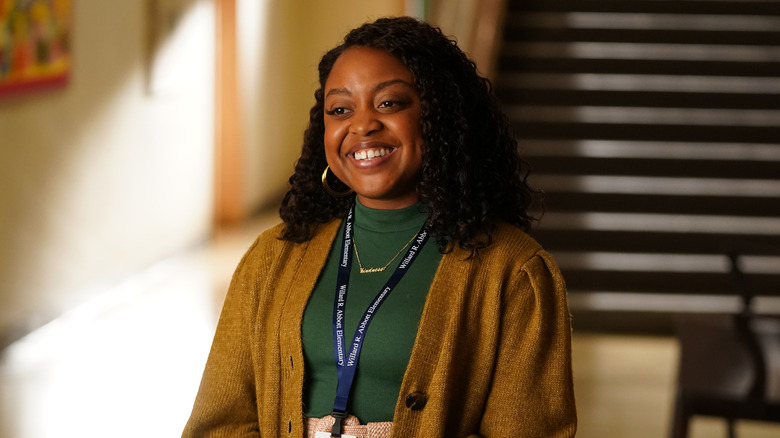 Janine Teagues smiling in a hallway