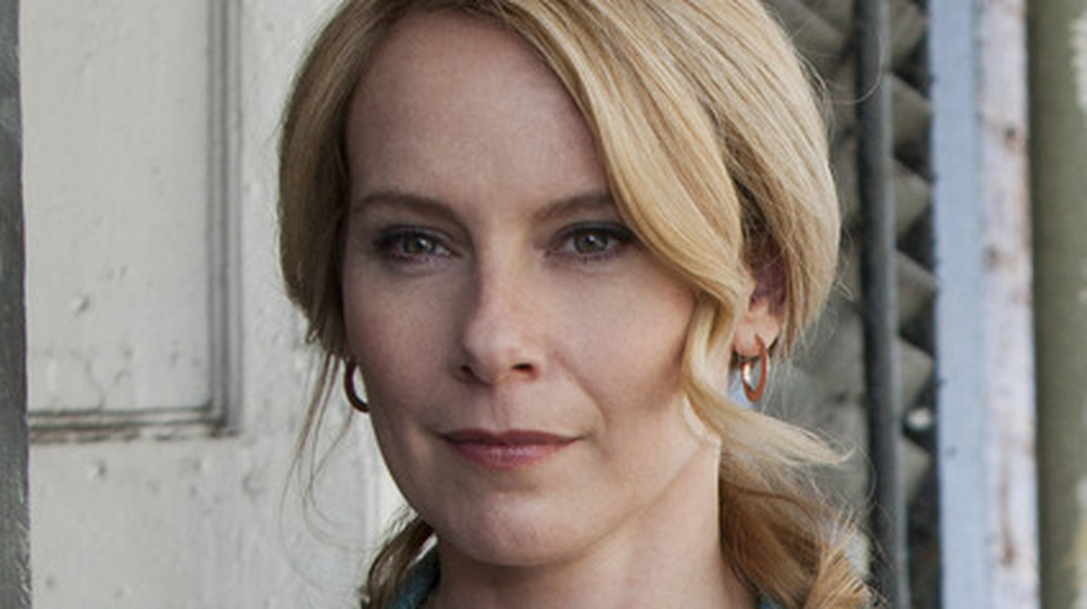 Amy Ryan as Abigail Ross standing with binoculars