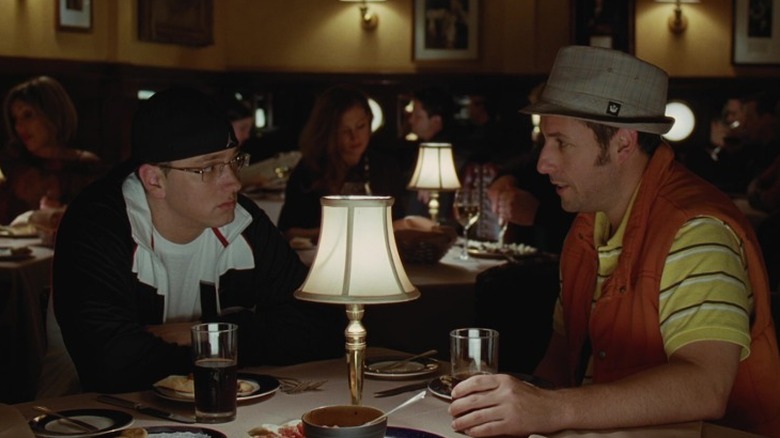 Eminem and George Simmons talk over a restaurant table in 